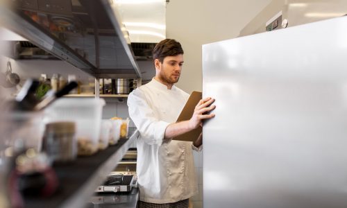 Chef opening a freezer in a resturants kitchen