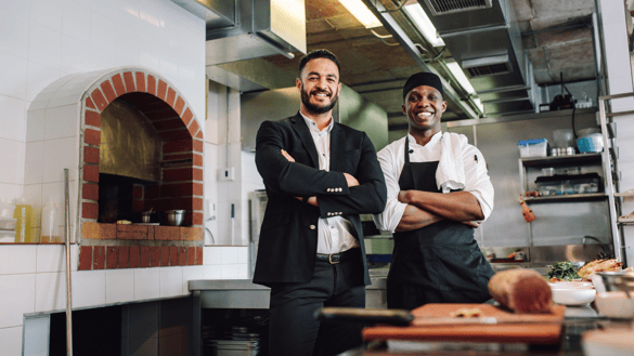 chef in the kitchen with restaurant owner